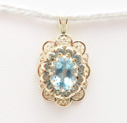 10k Yellow Gold Oval Blue Topaz with Blue Topaz Halo Scalloped Pendant
